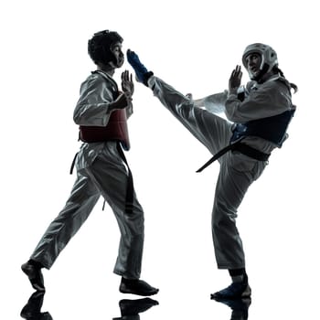 one couple man woman couple exercising karate taekwondo martial arts in silhouette studio isolated on white background