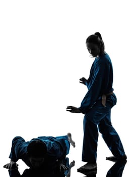 one  man woman couple exercising karate vietvodao martial arts in silhouette studio isolated on white background