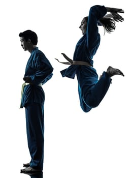 one  man woman couple exercising karate vietvodao martial arts in silhouette studio isolated on white background