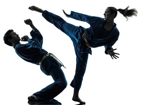 one  man woman couple exercising karate vietvodao martial arts in silhouette studio isolated on white background