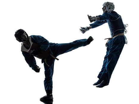 one causasian man exercising martial arts in silhouette studio isolated on white background