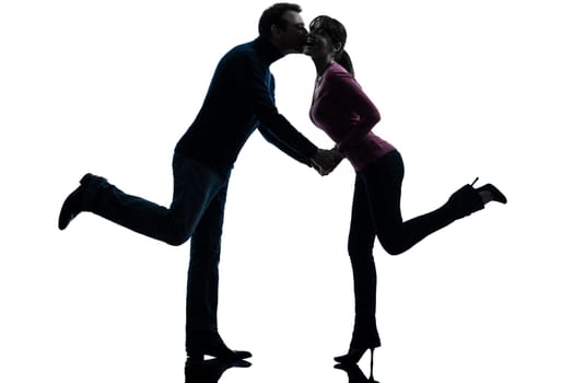 one caucasian couple woman man lovers kissing    in silhouette studio isolated on white background