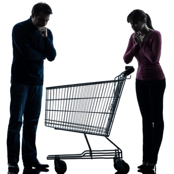 one caucasian couple woman man sad with empty shopping with shopping cart  in silhouette studio isolated on white background