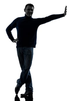 one causasian man full length in silhouette studio isolated on white background