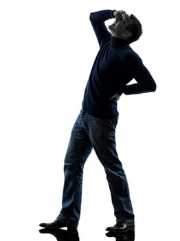 one causasian man full length in silhouette studio isolated on white background