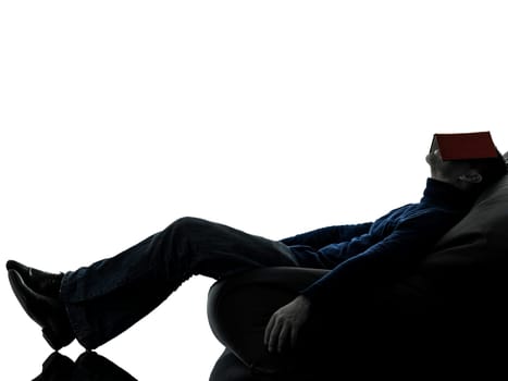 one causasian man reading book full length in silhouette studio isolated on white background