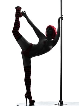 one caucasian woman pole dancer dancing in silhouette studio isolated on white background