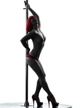 one caucasian woman pole dancer dancing in silhouette studio isolated on white background