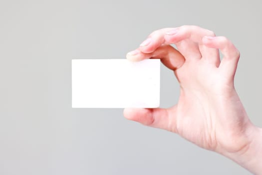 bussines card in hand for your information and logo in a grey background