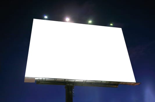 Blank illuminated billboard over evening sky