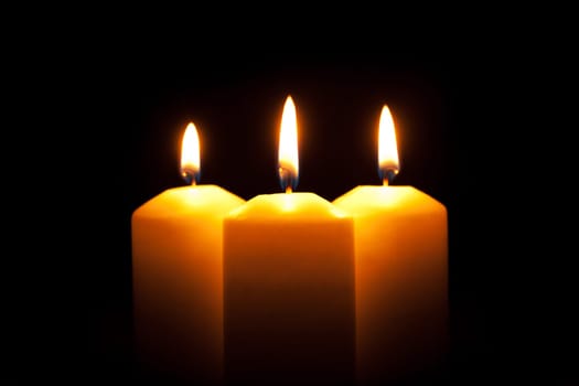 Glowing candles,candlelight against black background