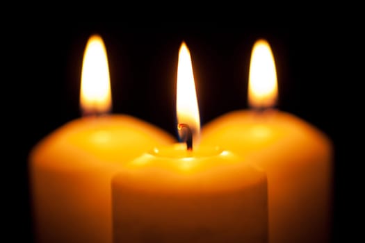 Glowing candles,candlelight against black background
