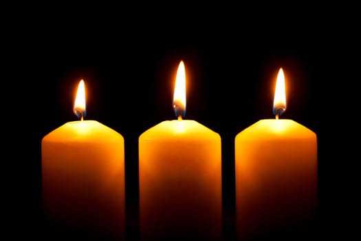 Glowing candles,candlelight against black background