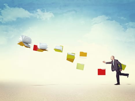 businessman follow flying file and documents