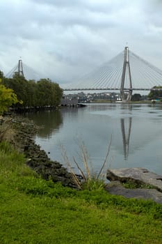 Anzac bridge in Sydney, lake and grass in foreground,