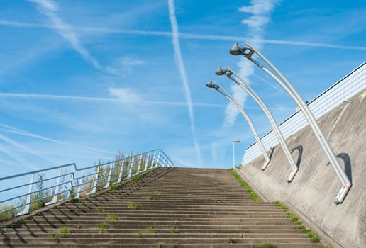 outside stairway with lampposts against a blue sky