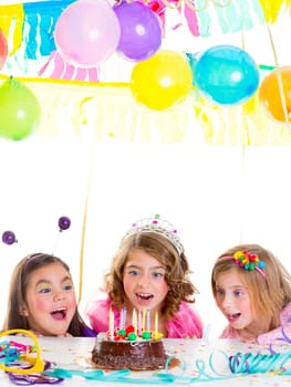 children kid girls birthday party looking excited chocolate candles cake