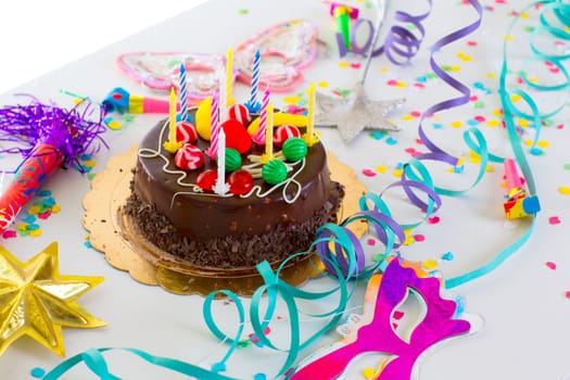Children birthday party with chocolate cake confetti garland and serpentine