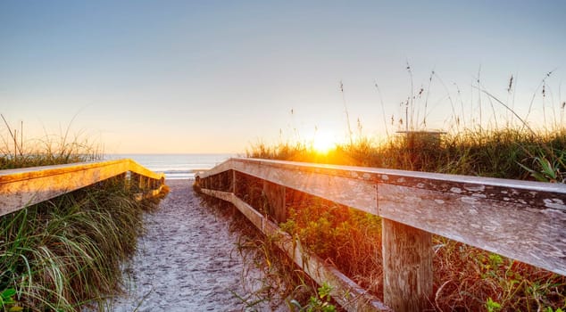 Sunrise in Cocoa Beach, Florida with Boardwalk.