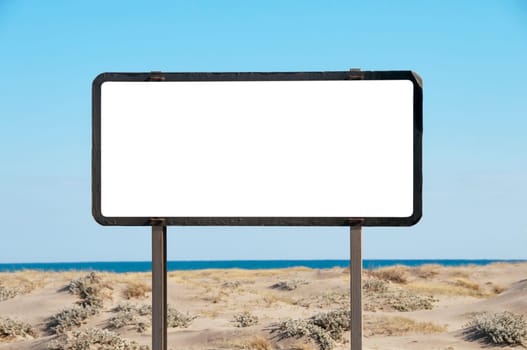 White billboard on the beach, blue sky, copy-space