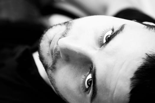 High angle view of a 20 year old man portrait, shot in studio from above.