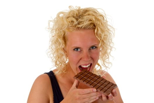 Young woman eating chocolate bar isolated on white background