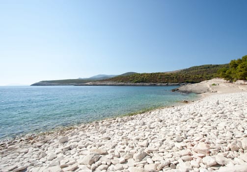 White stony beach in Croatia wiht sunshine