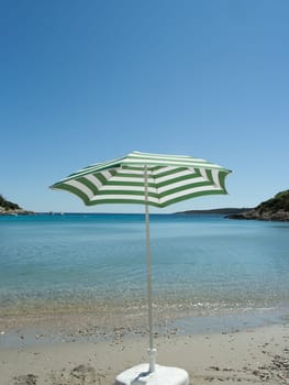 Parasol on the sand beach (Vis, Croatia)