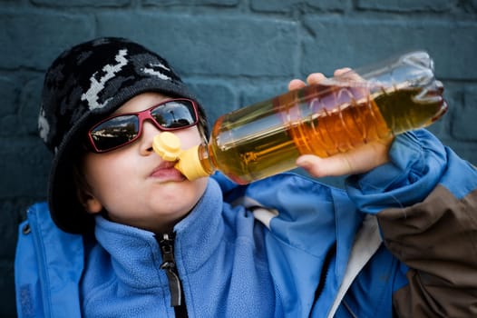 cool boy is drinking softdrink