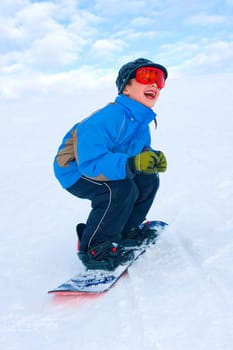 Boy is snowboarding