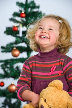 happy girl in front of christmas-tree