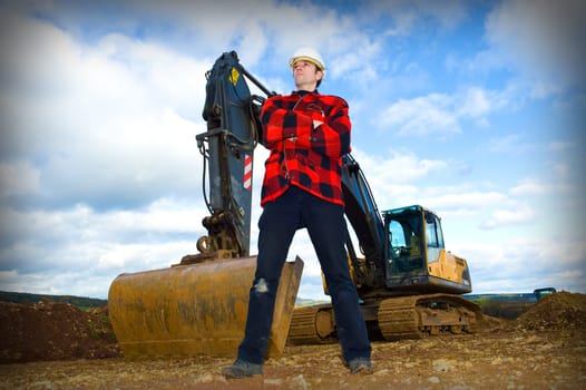 building worker in front of excavator