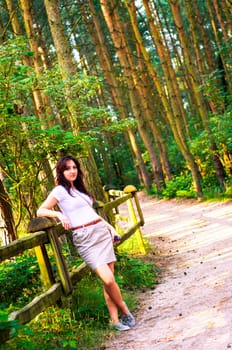 An image o girl walking through the forest pathway