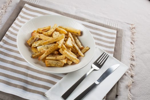 Cut roasted parsnips or potatoes with herbs.