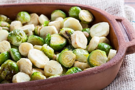 Brussels Sprouts and sliced parsnips roasted in a terracotta pan