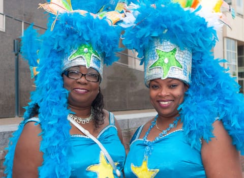 two colorful dressed women during the 8th salsa and samba festival in Nijmegen, Netherlands. The whole weekend hundreds of dancers and artists are entertaining the people