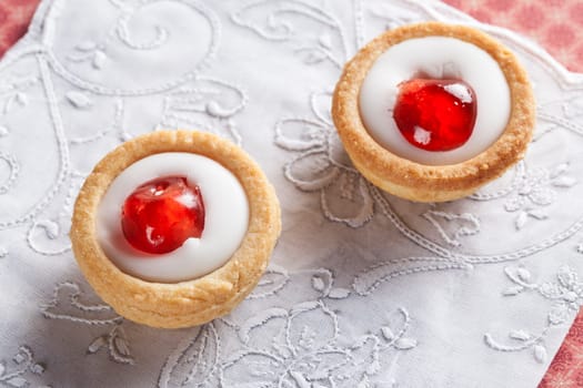 Sweet bakewell pastry treats on white napkin.