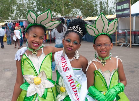 three colorful dressed girls during the 8th salsa and samba festival in Nijmegen, Netherlands. The whole weekend hundreds of dancers and artists are entertaining the people