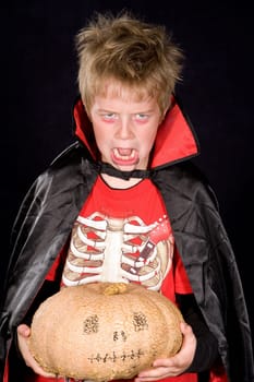 wild boy in halloween- outfit with pumpkin