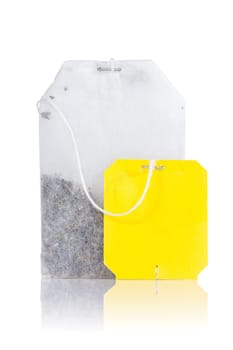 Teabag with yellow label. Isolated on white background