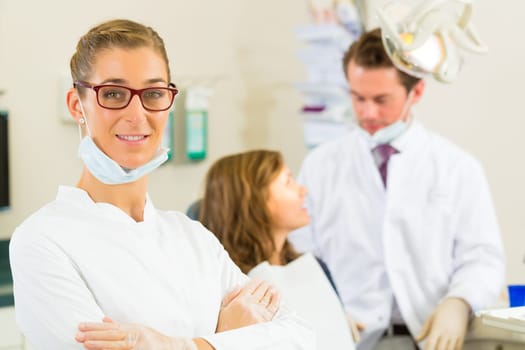Practice,in the background a patient receives a treatment from a colleague