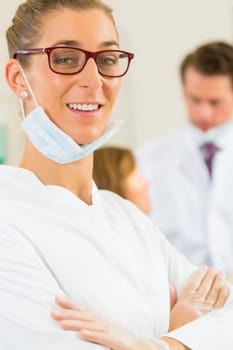 Practice,in the background a patient receives a treatment from a colleague