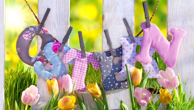 Easter decoration in the garden at the fence
