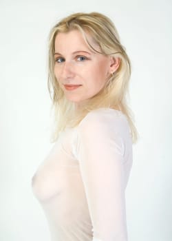 Young beautiful blonde woman with fair skin and elegant delicate lingerie
