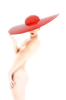 Female nude hi key with big red hat in side view
