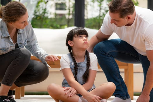 Parents comforting their daughter with loving embrace, helping her feel secure and protected from fear, rest her head on shoulder and sadness melts away. Family love and child care concept. Synchronos