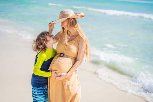 A radiant pregnant mother and her excited son share a tender moment on a serene, snow-white beach, celebrating family love amidst nature's beauty.