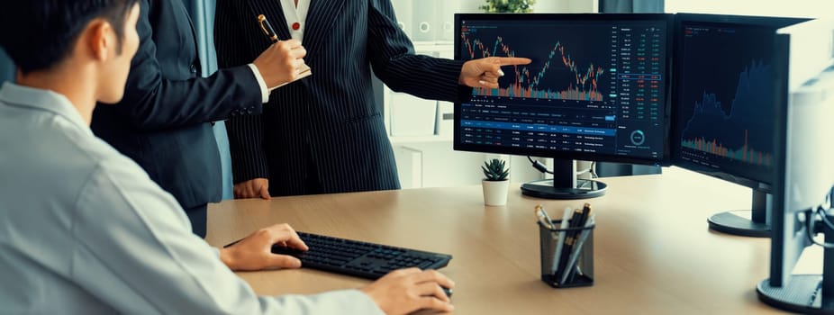 Group of profession trader discuss about stock market investment while point the increasing financial graph displayed on computer. Stock market investment concept Cropped image. Burgeoning.