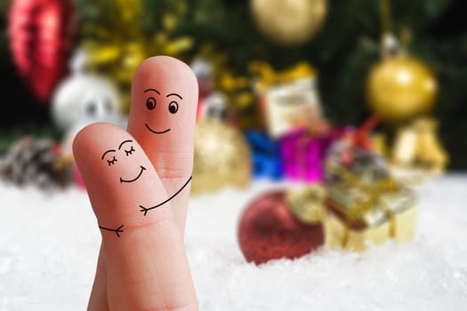 Faces of fingers hugging each other isolated on Christmas decorated background. Happy family celebrating Christmas day concept