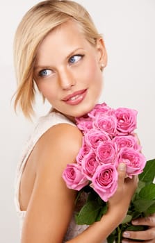 Flowers, bouquet and rose with woman in studio for floral, valentines day and romance gift. Plants, beauty and happy with face of female person on white background for elegant, love and present.